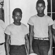 In this undated image released by the State Library and Archives of Florida, Lake County Sheriff Willis McCall, far left, and an unidentified man stand next to Walter Irvin, Samuel Shepherd and Charles Greenlee, from left, in Florida. The three men along with a fourth were charged with rape in 1949. Florida Gov. Ron DeSantis and a Cabinet granted posthumous pardons Friday, Jan. 11, 2019, to Shepherd, Irvin, Charles Greenlee and Ernest Thomas, the four African-American men accused of raping a white woman in 1949 in a case now seen as a racial injustice.